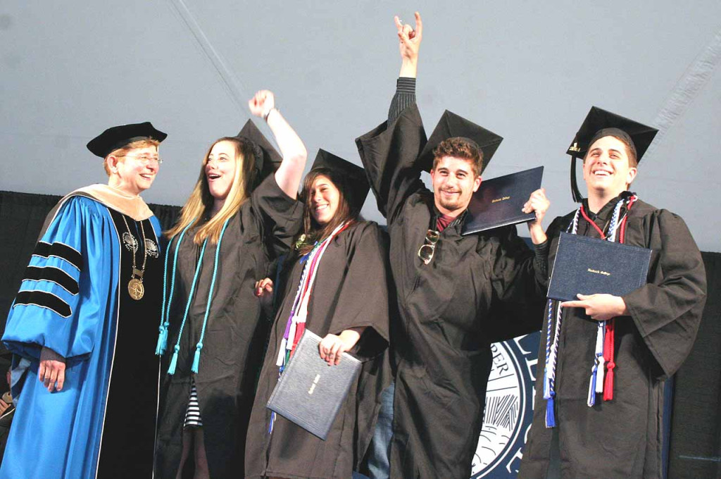 The Mele quadruplets of Long Island – Erin, Grace, Danny and Bobby – stand with Hartwick College President Margaret Drugovich on the stage after receiving their diplomas from the college. The four marked a first for Hartwick, the first set of graduating quadruplets to graduate in the colleges' 217 years