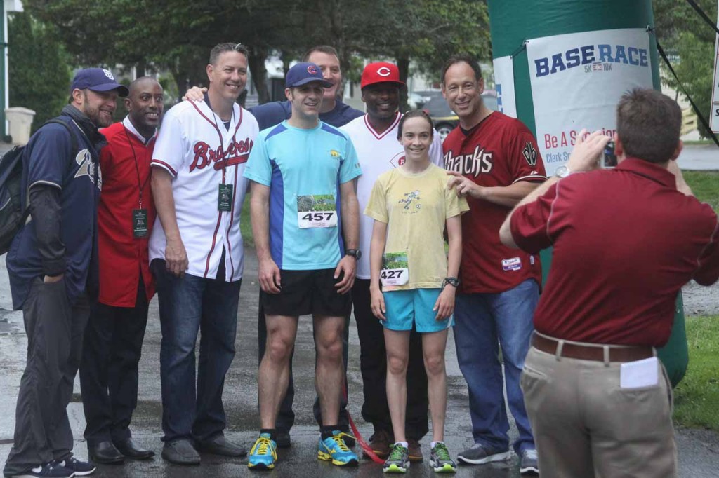 Surrounded by MLB players who will participate in this afternoon's Hall of Fame Classic, BASE Race 5K winners Daniel Nensteil of Drums, Pa., and Cooperstown's Heidi Edmonds, 14, pose for Hall of Fame VP Brad Horn's camera.  (Jim Kevlin/allotsego.com)