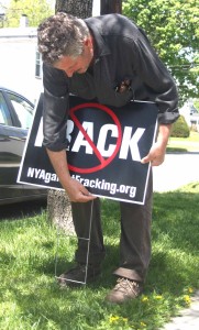 Russ Honicker, Cooperstown, installs anti-fracking signs along Susquehanna Avenue on Tuesday, May 20 ahead of President Obama's visit 