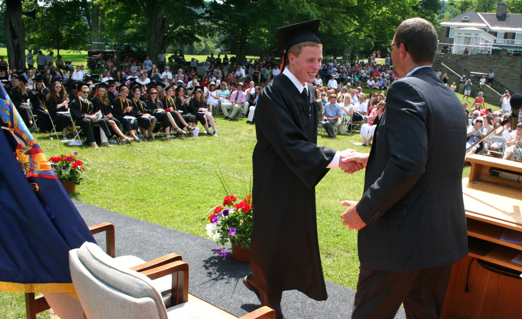 Nicholas Lawson, arrives on stage to accept his diploma from President Michael Cring, at the 135th annual commencement that was held on the lawn of the Fenimore Museum. 