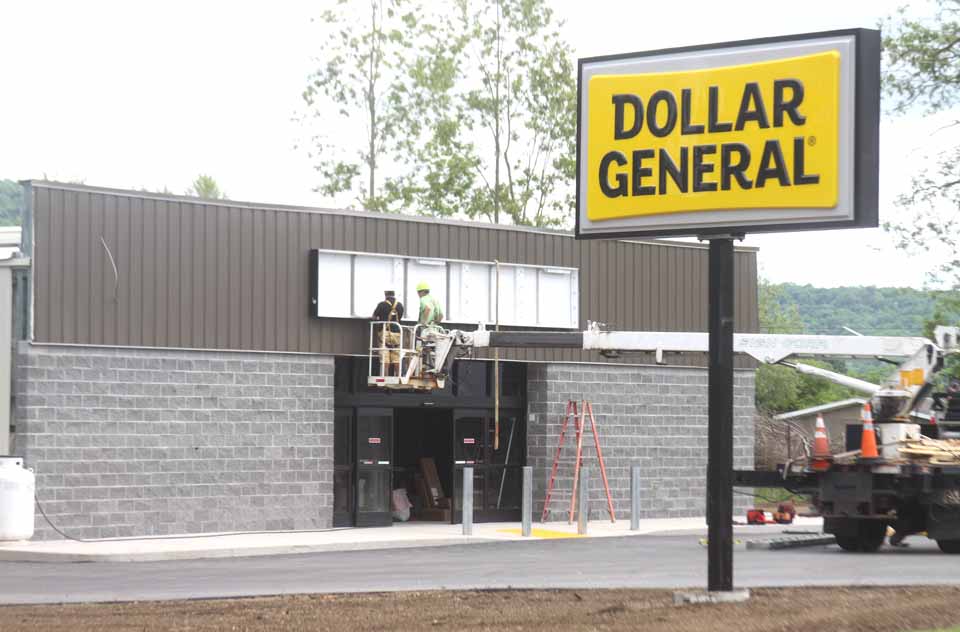The signs went up this afternoon at the Dollar General variety store that is opening shortly in Hartwick Seminary.  (Jim Kevlin/allotsego.com)