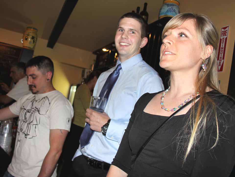 Kirsten Oehl, Hartwick College's internship coordinator, and Phil Wright, a realtor with the Benson Agency, welcome 60-some people to Citizen Voices' first reception for young professionals last evening at Ristorante Stella Luna, Oneonta. (Jim Kevlin/allotsego.com)