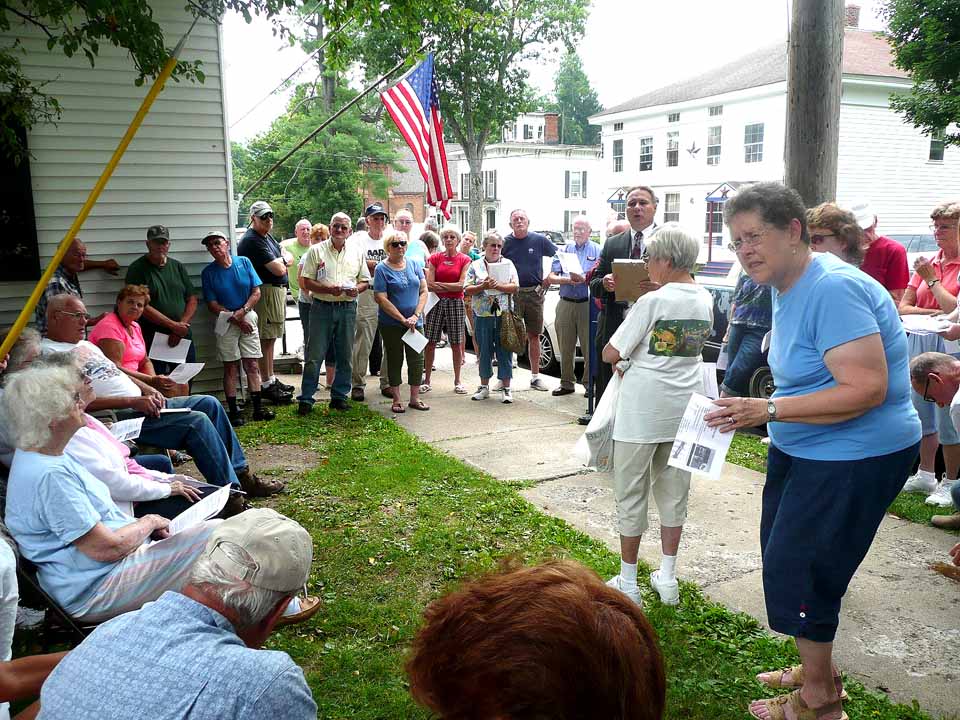 Regional postal manager David Clark had to move today's meeting on the future of the Gilbertsville post office outdoors after 75 concerned residents showed up.  (Teresa Winchester/allotsego.com)