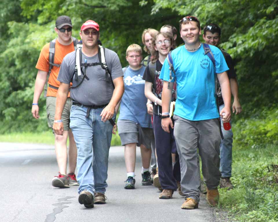 Drivers along County Route 35 between Portlandville and Milford this afternoon would have happened upon this group of Scouts from the Crumhorn camp completing a 10 mile hike required for the hiking badge. In the front are Scoutmaster Samuel Miller, left, of Fultonham, Montgomery County, and Damian Laird, Sidney. Behind them, from left, are Andrew Work, Fultonham, Logan Doucas, Cooperstown, Eric Buskey, Fultonham, Chase Sutliff, Sidney, Christian Buskey, Fultonham, and Irving Skowjoe,Oneonta. (allotsego.com)