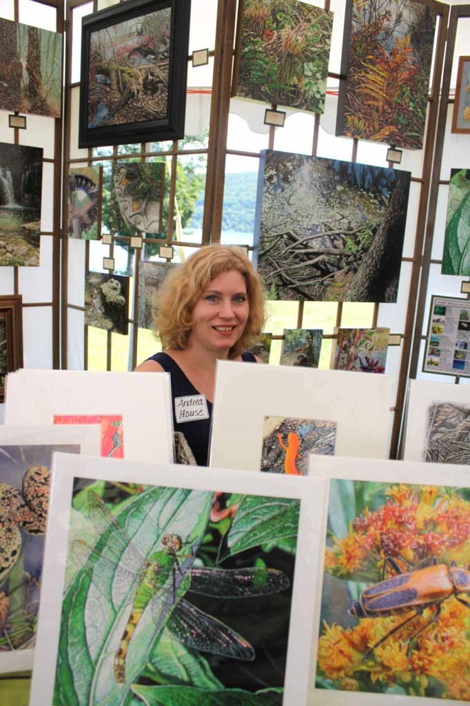 Springfield Center artist Andrea House sits amid nature, depicted in her works, at today's "Art By The Lake" that continues until 5 p.m. on the back lawn of The Fenimore Art Museum. (Jim Kevlin/allotsego.com)