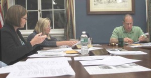 Trustee Cindy Falk, left, seeks to convince her colleague of the wisdom of a "hospital zone," but ended up as the sole "aye" in a procedural vote.
