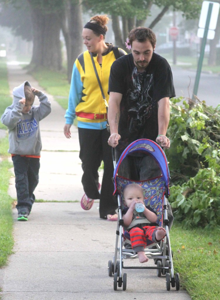 Joseph Meyers, 4, is walked to his first day of kindergarten at Cooperstown Elementary School this morning by mom Keri O'Connor and D.J. Nash, and his younger brother Jacob Nash, in stroller.  (Jim Kevlin/allotsego.com)