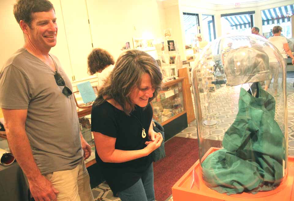 Corena and Jim Martin, Laurens, examine Alice Hull George's gym suit and frosh cap from 1931, part of "Passing Through the Pillars," which opened Friday at the Oneonta History Center in conjunction with SUNY Oneonta's 125th anniversary celebration. Lois Illick donated her mother's gym clothes. (Jim Kevlin/allotsego.com)