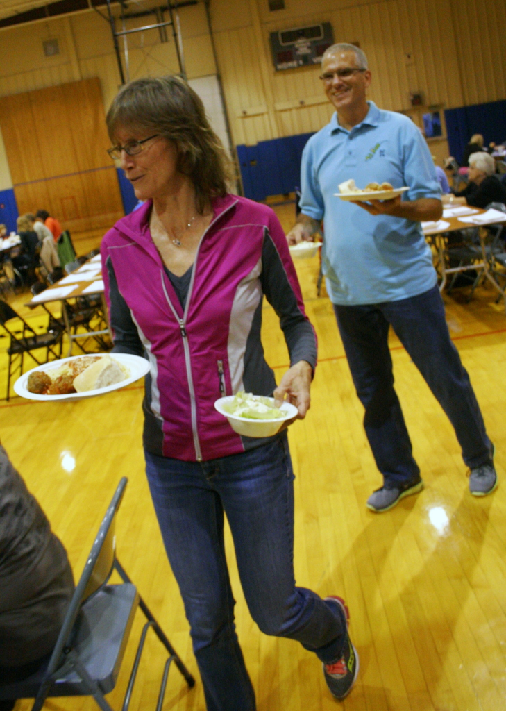Deb and Sid Parisian carry plates of meatballs at the annual Pit Run Spaghetti Dinner, which was held Saturday night at the Oneonta Boys and Girls Club.