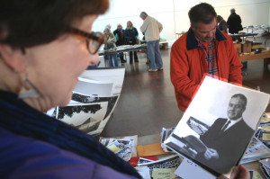 Janet Potter, CCS '66, now president of the Greater Oneonta Historical Society, examines a photo of Jim Robinson, assistant principal when she was at the high school.