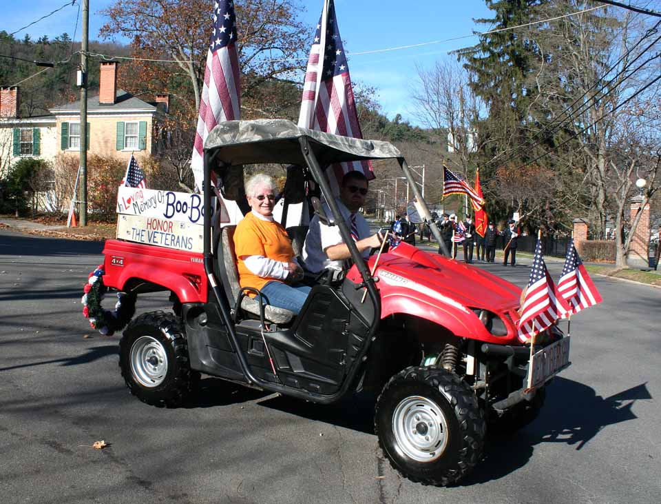 Georgia Goodspeed, widow of Gerald "Boo Boo" Goodspeed, a former National Guardsman who passed away in May, was grand marshal of this morning's parade. Mike Gage drives.