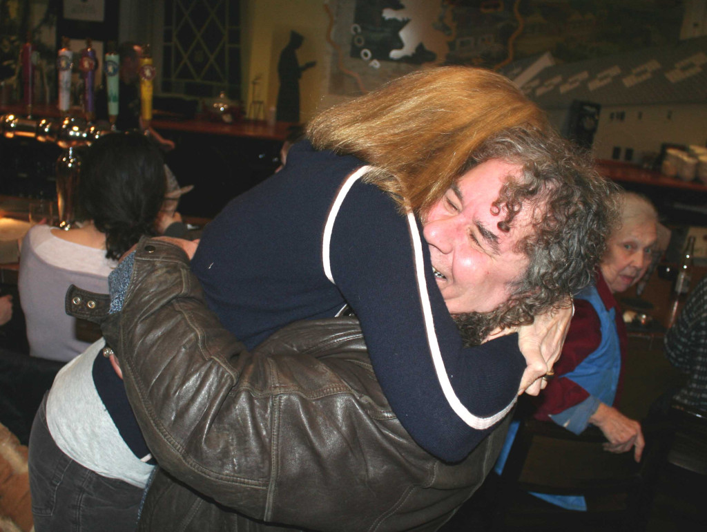 Otsego 2000 President Nicole Dillingham gives a big hug to fellow fracking foe Bob Eklund at a celebration now underway at Cafe Ommegang following today's news that Governor Cuomo is banning fracking in New York State. "This is historic, this is euphoria," Dillingham said when more formal remarks were solicited during the gathering. "This is not for us. This is not for our families. This is not for our children," Eklund said of the controversial fracking process. (Jim Kevlin/The Freeman's Journal)