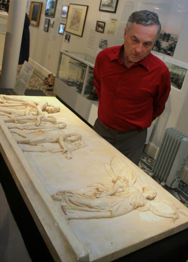 At the Greater Oneonta Historical Society's Lost Oneonta show  Wayne Wright, Oneonta, looks at a plaster relief that used to hang above a doorway in the former Oneonta High School on Academy st, which he used to attend.
