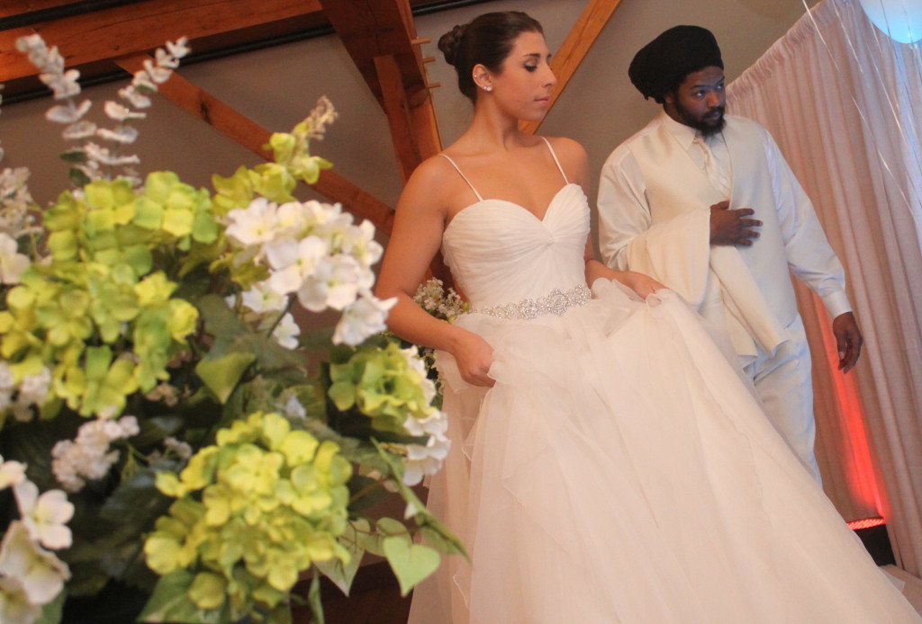 SUNY Student Sabrina Yunque, and Noble Champen, Oneonta, model some of the latest fashions on the runway of the House of Brides Love Is In The Air Bridal Show, hosted at The Carriage House on Sunday afternoon.