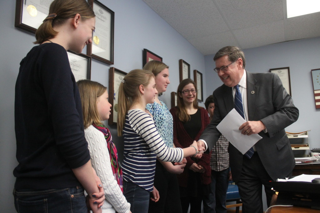 State Sen. Jim Seward, R, Milford, shakes hands with Cooperstown Central students Mikeeli Hanson, Natalie Hanson,Hazel Lippitt, Sarah Parrl, Josie Hovis and Ray Hovis at his Oneonta office who presented him with  a student-initiated petition expressing opposition to Governor Cuomo’s proposal Common Core reforms as well as a list of signatures supporting their views. 