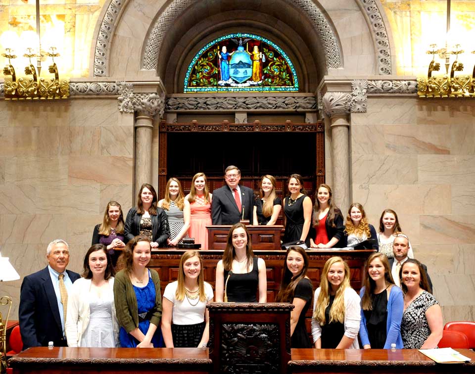 Senator Jim Seward, back row, center, poses in the state Senate chambers with the CCS Lady Hawkeyes state champion basketball team and coaches Mike Niles, second row, right, and Glen Noto, first row, left.