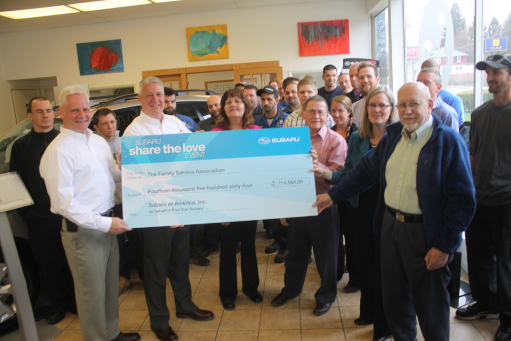 Blaine Jennings and Ben Guenther of Five Star Subaru present a check fo $14, 564 to Kim DeFalco, Rudy Ballard, Vicki Salmon and Fred Albrecht of Family services. The donation comes from Five Star Subaru's Share the Love Event back in Dec. where anyone buying a car could donate part of the purchase cost to the cause. This is the first year that they have been able to donate to a local charity. (Ian Austin/ allotsego.com)
