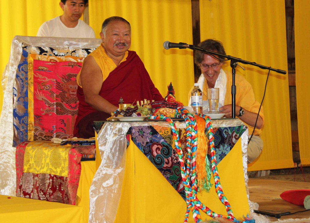 Matthew Zalichin kneels next to Choklin Rinpoche during his visit to Rangjung Yeshe Gomde in 2012.
