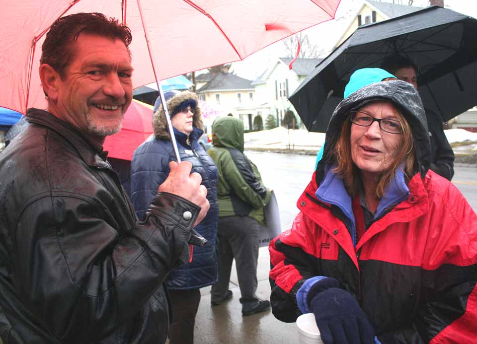 Kevin Clark, outgoing president of the Unatego Teachers Association, and Danielle Boudet, Morris, a leader of Oneonta Area for Public Education, chat during a rally they helped organize Thursday, March 26, at Oneonta's former Center Street School, now the school district offices. (Jim Kevlin/allotsego.com)