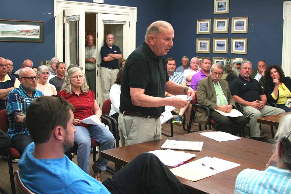 Former village Planning Board chair Charlie Hill tells the Zoning Board of Appeals this evening, "I'm concerned this proposed structure goes way to far." He was among 17 who testified at a ZBA hearing on a proposed downtown hotel for Cooperstown; only two who testified favored the project. ZBA chair Susan Snell outlined eight variances, all having to do with height, that will be necessary for the hotel project to move forward. After closing the hearing, the ZBA decided to wait to vote on the height question until its next meeting, Tuesday, June 2. The Village Board has schedule a hearing for Monday, June 29, on the special permit it must issue before any hotel project can go forward in the Business District. (Jim Kevlin/allotsego.com)