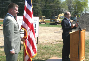 After catching Old Glory before it could his the ground, Congressman Gibson stood sentinel by the flag through the rest of the ceremony, including remarks by Bill Streck, right.