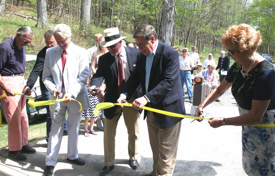 Cutting the ribbon at this morning's rededication of Hyde Hall's Tin Top gatehouse are, from left, former board chair Andy Blum;, Matthew Cook, who worked on the project; current board chair Gib Vincent; Executive Director Jon Maney; Senator Seward and Deputy State Parks Commissioner Ruth Pierpont. (Jim Kevlin/allotsego.com)
