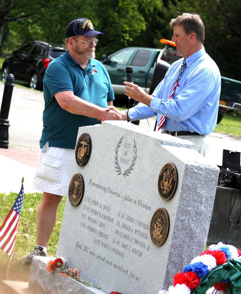 Oneonta Mayor Russ Southard, right, congratulates Vietnam-era veteran Gene Schmit, an OHS grad now living in Unadilla, for his successful drive to raise funds for a Vietnam monument dedicated this morning in Neahwa Park.  Schmidt raised $6,200 last fall to remember the nine OHS grads who died in Vietnam; he knew six of them personally; three were in his class.  (Ian Austin/allotsego.com)