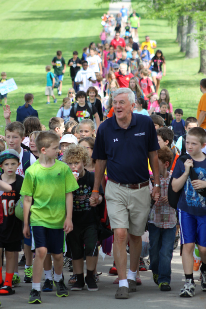 Nearly 100 students, friends and co-workers gave Sharkey Nagelschmidt, center, Cooperstown, an honorable send off by walking with him from CCS to the Clark Sports Center, where he will be holding his last day of children's after school activities before his retirement. (Ian Austin/ allotsego.com)