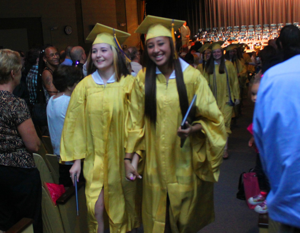 Izabella Corbett and Destiny Torres  walk out to a standing ovation during the recessional of the 146th OHS graduation on Saturday Afternoon at the Belden Auditorium. (Ian Austin/ allotsego.com)