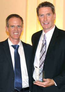 David Salway, left, executive director of the state Broadband Program Office, presents the Leadership Award to MIDTEL's Jim Becker.