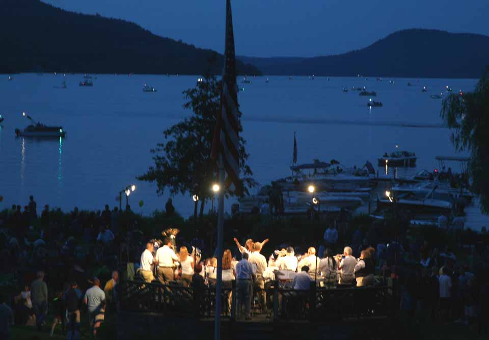 Cooperstown Community Band Director Julie Solomon prepares to cut off the players on the final note of "Stars & Stripes Forever" in Cooperstown's Lakefront Park this evening as the crowded awaited the fireworks.  (Jim Kevlin/allotsego.com)