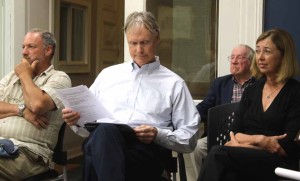Chip Northrup reviews his notes after reviewing his plan with village trustees to make Brookwood financially self-sufficient . He is flanked by wife Nancy and resident Jeff Lewis. Behind him is former mayor Wendell Tripp, who spoke against the village taking on any additional financial liability.