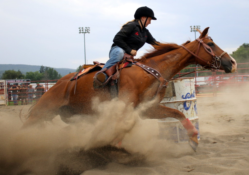 The makeshift rodeo ring made for tricky maneuvering for the riders and there horses. Here, Courtenay Chambers, Jefferson, rides her horse through a tight turn during the barrel races. (Ian Austin/ AllOTSEGO.com)