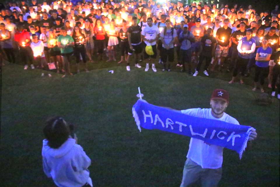 Penny Wightman, left, shares the story of a Hartwick scarf, held by Dante's best friend, Korey Jubie, that Dante knit for extra credit. (Ian Austin/allotsego.com)