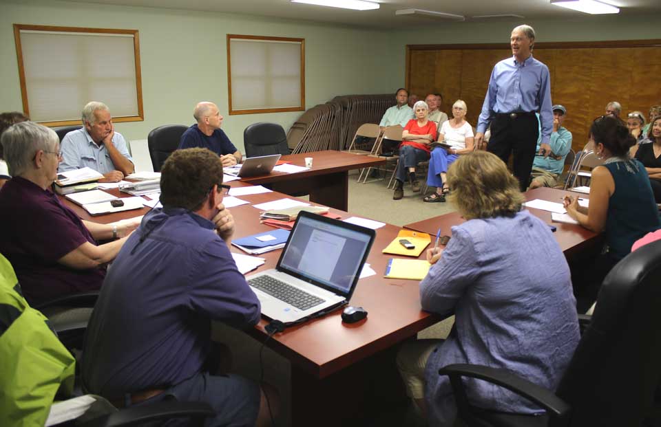 After hearing a presentation from Chip Northrup, Cooperstown, the Otsego Town Board last evening expressed its support for possibly turning Brookwood Point into a town park, and scheduled a meeting for 5 p.m. Monday, Sept. 21, to begin working on particulars. Seated, counterclockwise from far side, are Town Board members Tom Hohensee and John Schallert, Supervisor Anne Geddes Atwell, Town Board member Bennett Sandler, Town Clerk Pam Dean and Town Board member Carina Franck. (Jim Kevlin/AllOTSEGO.com)