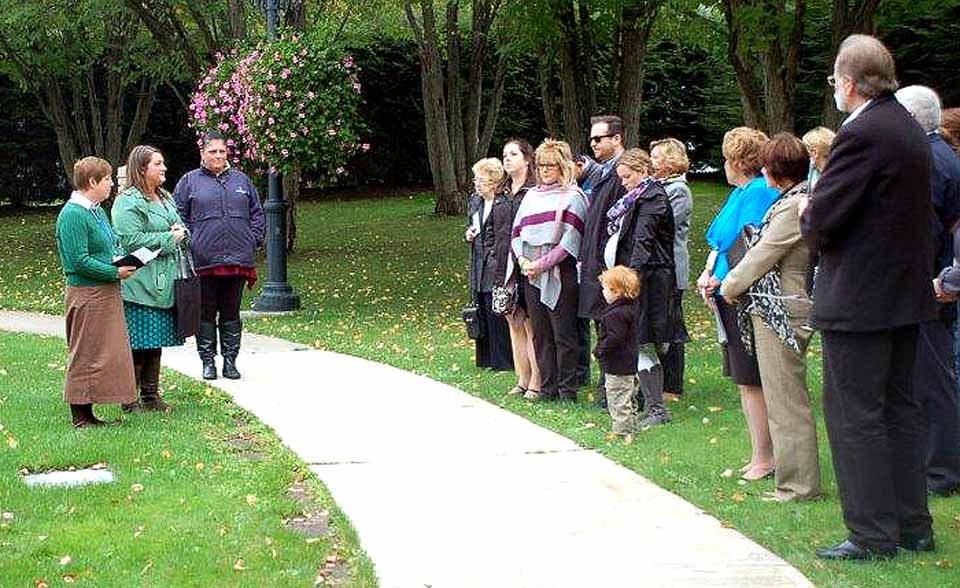 The family, friends and staff from Bassett Hospital gather for a flag-raising ceremony Friday, Oct. 2. The ceremony honored a local organ donor whose gifts of life helped save two other New Yorkers. (Bassett photo)