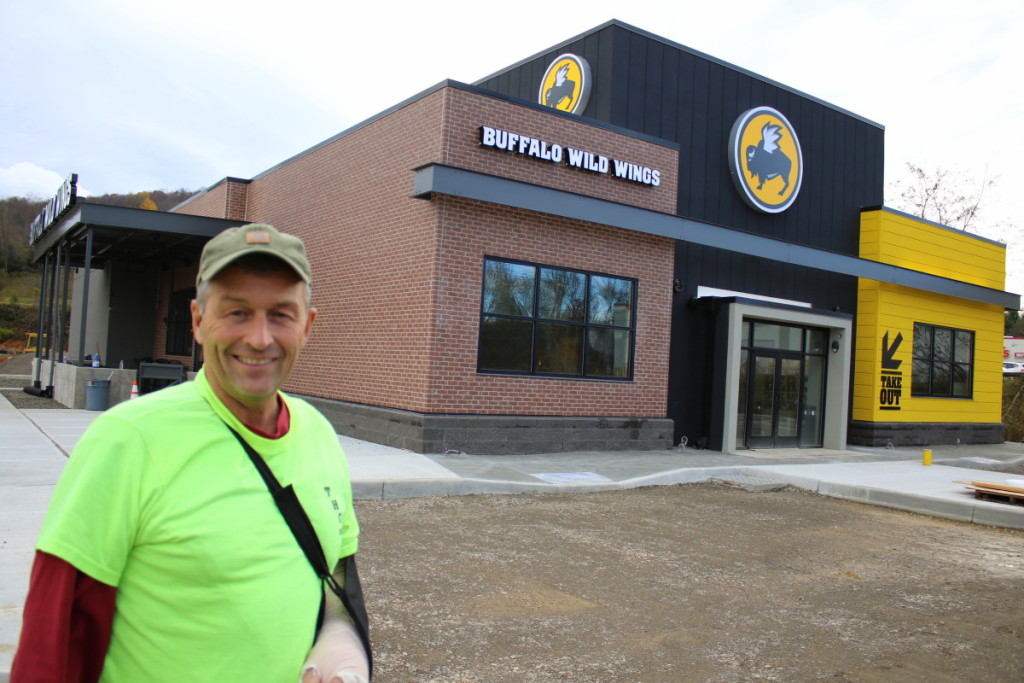Tom Howard, owner of Tom Howard Construction, Inc stands outside his crew's newest project, the Buffalo Wild Wings going up on Oneonta's Southside. "We took over the job from another contractor and will be able to deliver it on time," he said. "The parking lot will be done on Monday, the inside is done and it will be ready for it's opening on Nov. 15." (Ian Austin/AllOTSEGO.com)