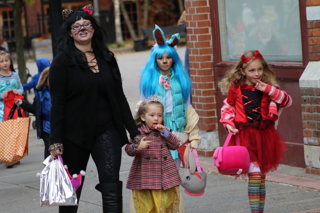 Christina Vasquez, Oneonta, trick-or-treats with her children Gaby, Anaya and Jada in downtown Onetona before the parade begins at 7pm.