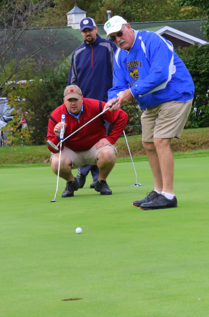 Thomas Harrington, OHS '72, tries for a put on the green under the watchful eyes of Zach Brown, '95, and Heath Ulter, '95, during the OHS Alumni Golf tournament at the Oneonta Country Club this morning. The event, which featured 29 teams, kicked off a weekend of events and celebration in honor of OHS Alumni weekend. (Ian Austin/ AllOTSEGO.com)