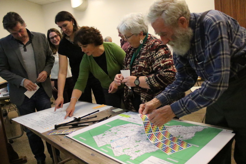 At a strategic planning meeting for Otsego County, local residents including Craig Gelbsman, Karen Sullivan Pat Knuth and Johnathan Gell, look over the list of top priorities with Nicole Allen, planning services manager, and Rebecca Yanus, Junior planner, at SUNY's IRC building tonight. Top concerns for our area included, expanded broadband internet, affordable housing and development of vacant agricultural land. Results from tonight's meeting will be added to ones from earlier today and presented on Tuesday. (Ian Austin/AllOTSEGO.com)