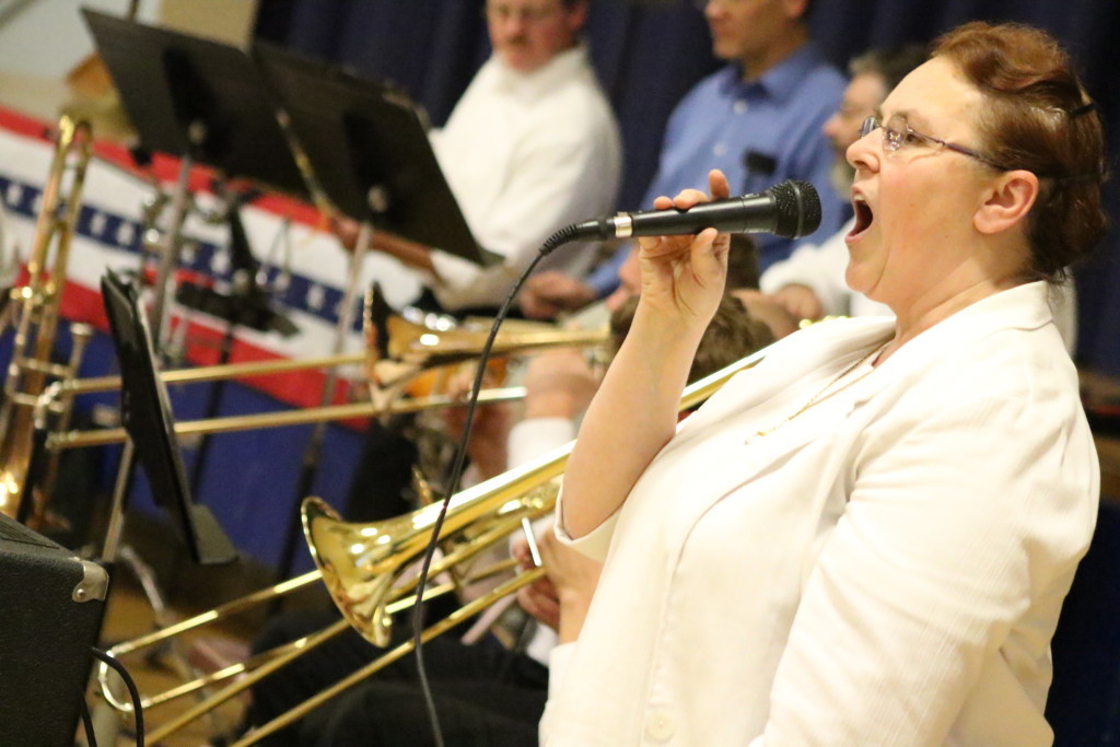 Soloist Rebecca Sabin preforms "God Bless America" at the Oneonta Community Concert Band's 15th Annual Salute to Veterans concert at Greater Plains elementary school this afternoon. The concert played historical military arrangements, concluding with Bob Lowden's "Armed Forces Salute", where area veterans stand and are recognized according to their branch of the military. (Ian Austin/AllOTSEGO.com)