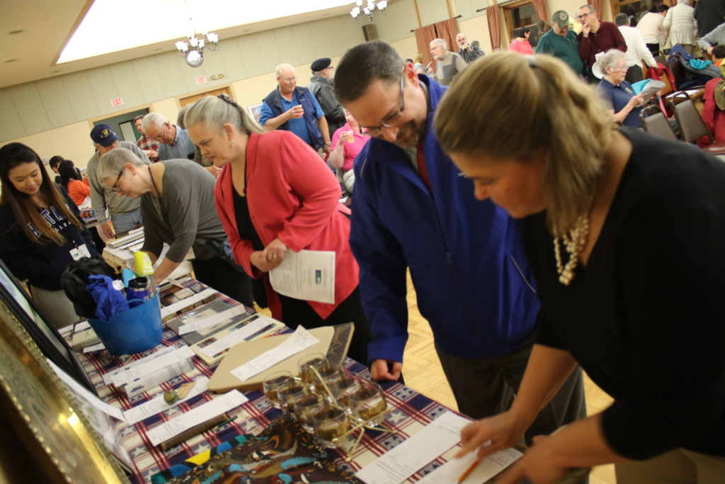Bidding was aplenty at the GOHS fundraising auction this evening at the Elks Club. Among the items were a steeple, a complete bound set of the works of James Fenimore Cooper, Ommegang beer, art and a spot to ride on the maiden ride of the new GOHS elevator. Here Alicia Fish, Dave Lubell, Michelle Sheer, Karen Anderson and Betty Qiu look over the goods and set their bids. (Ian Austin/ AllOTSEGO.com)