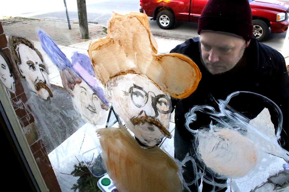 While Richfield Springs youngsters were painting Main Street windows with Christmas themes, artist Kurt Zurmulen had another idea for the Historical Society: portraits of all New York State's president. Here, he paints Teddy Roosevelt, but can you name all the U.S. presidents from our Empire State? Here's the answer. (Jim Kevlin/AllOTSEGO.com)