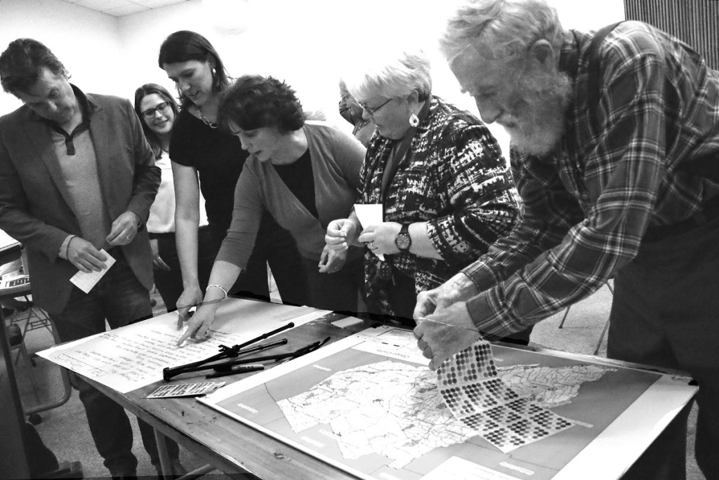 Oneonta residents, from right, Johnathan Gell and Pat Knuth examine a priority list at the evening session for the general public at SUNY Oneonta Thursday, Nov. 5. Others are, from left, county Rep. Craig Gelbsman, Laberge Junior Planner Rebecca Yanus, Planning Services Manager Nicole Allen and county Planning Director Karen Sullivan.