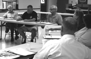 Oneonta Mayor Gary Herzig tells Laberge Vice President Ben Syden, foreground, the county’s ec-dev effort has lost focus. Next to Herzig are Supervisors Joe Hurlburt, Otego, and Greg Relic, Unadilla.