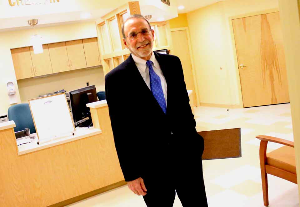 Dr. William Streck, Cooperstown, stands in the lobby of the newly completed William F. Streck Health Center, named in his honor at tonight's reception at Pathfinder Village. The Bassett clinic, which opens to the public on Monday, Nov. 9, features five exam rooms, a considerable upgrade from the former Edmeston clinic, a one-room space in a converted farmhouse. In addition to serving the public, the clinic will also provide Pathfinder residents with access to dental care. (Ian Austin/AllOTSEGO.com)