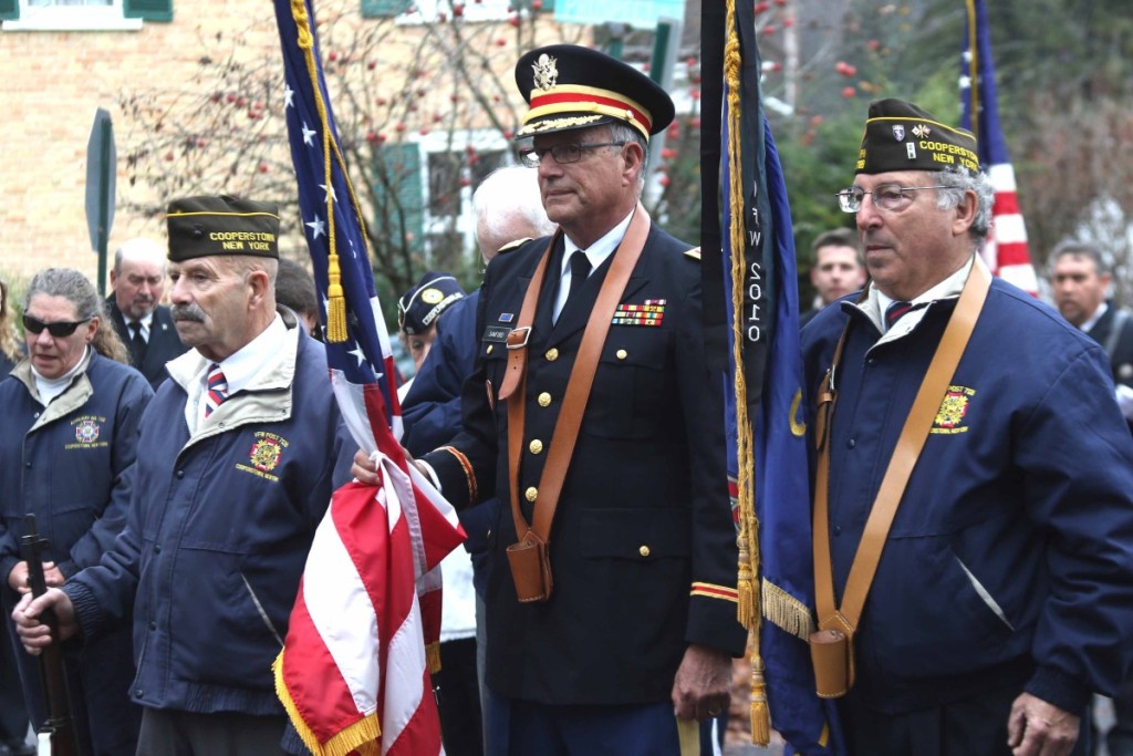 The honor guard at this morning's Veterans' Day Parade in Cooperstown are, from left, Paul Elkins, David Sanford and Frank Capozza. The commemoration of soldiers' sacrifices, including a burning of used flags, took place at the village's "doughboy" statue at the foot of Pine Boulevard, across from The Otesaga. (Jim Kevlin/AllOTSEGO.com)