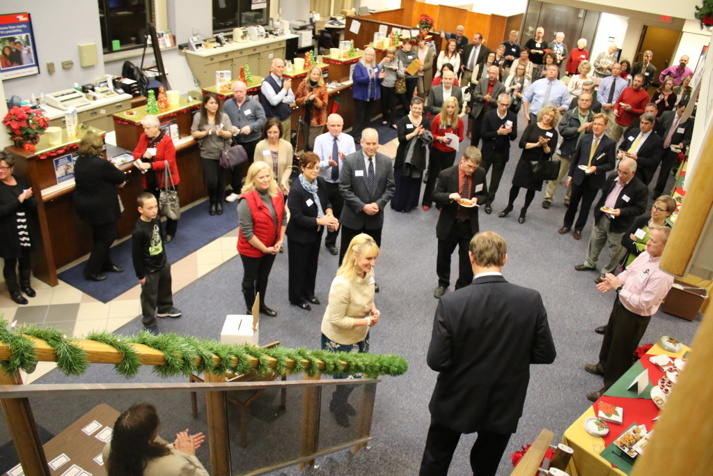The Otsego County Chamber of Commerce held a holiday party at NBT Bank tonight honoring their 30th year. Jamie Reynolds, lower left, introduced Chamber President Barbara Ann Heegan who spoke on how small businesses who drive our local economy need more support, and that this year will focus on bringing more 'home owner type jobs'. "We are here to support you!" said Heegan. (Ian Austin/AllOTSEGO.com)