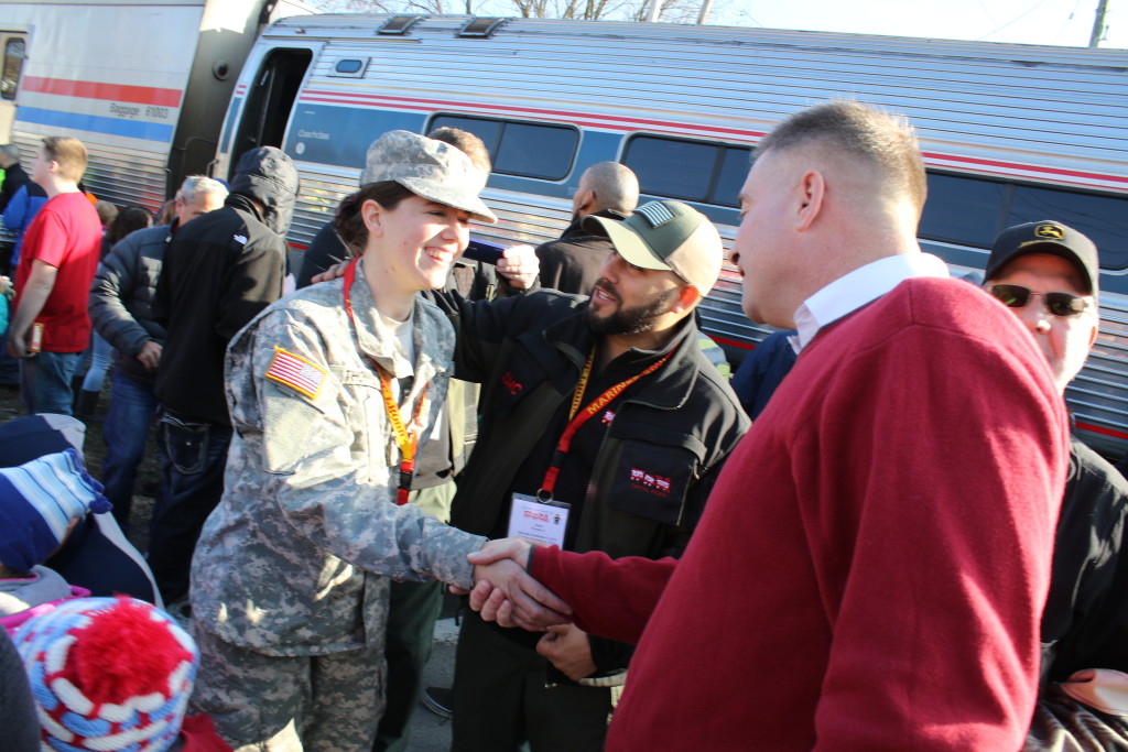 Kate Thomas, Kinderhook, an Army volunteer for Toys For Tots, sought out Congressman Chris Gibson in the crowd at their Oneonta stop this afternoon to thank him for representing her hometown. The train , which made it's way through the region this afternoon, handed out toys, cookies, coats and hats to children and families along the route. (Ian Austin/AllOTSEGO.com)