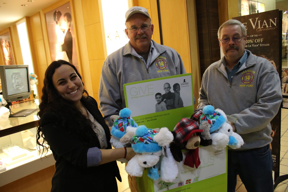 Victoria Ayala, manager of Kay Jewlers in the Southside Mall, stands with a box of stuffed bears and dogs they are donating to the Franklin Fire Department, received by Chief Tom Worden and 1st Asst. Chief Dale Downing. "The toys were from the St. Jude Bears drive." explained Ayala, "The money goes to the children's hosp[pital and people can choose to take the toys home or donate them. This year we decided to donate them." "We carry the bears in the ambulance to give children if they are sad or scared." said Worden, " We bring them to structure fires or house calls, wherever there may be a child in need." The Franklin Fire Department has kept this practice for years, with the emergency crews purchasing the toys themselves. "We give out 10-20 stuffed animals a year." said Worden, "And this year Kay Jewlers approached us with the idea of the donation and we said 'absolutely!' " 
